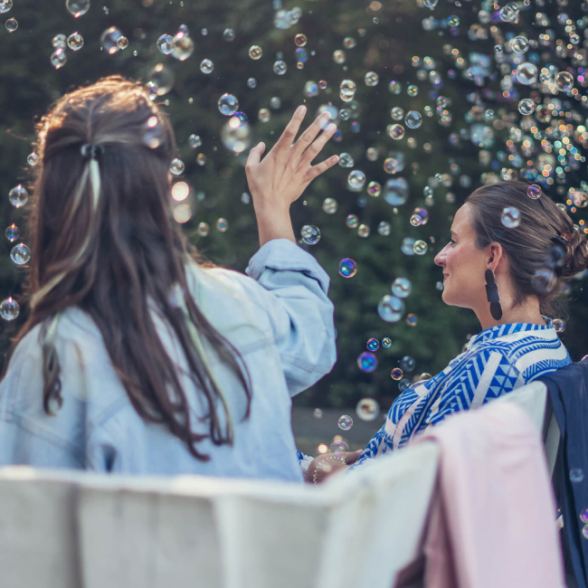 zwei sitzende Frauen für Teamevent Sommerfest